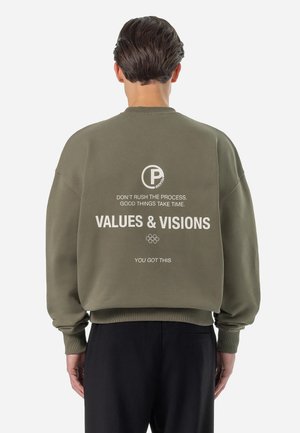 Olive green sweatshirt with a relaxed fit, crew neckline, and ribbed cuffs. Features white printed text and logo on the back.