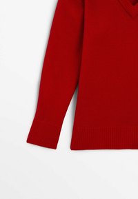 Pull en laine rouge avec un décolleté en V, des poignets et un ourlet à côtes, présentant une couleur unie et une texture lisse.