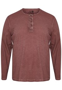 Maglietta a maniche lunghe stile henley in un borgogna sbiadito, con un'apertura a cinque bottoni, scollatura rotonda e vestibilità comoda. Tessuto morbido e lavorato.