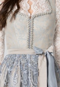 Traditional dress with light blue floral-embroidered bodice and lace sleeves. Features a satin ribbon and intricate gray lace skirt.