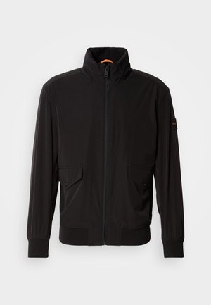 Black lightweight jacket with a high collar, zip closure, and two front pockets. Features ribbed cuffs and hem, smooth texture, and orange accent.