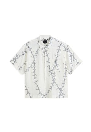 Short-sleeve, collared shirt in white fabric, featuring a gray thorn pattern and a front pocket. Button-up design completes the look.