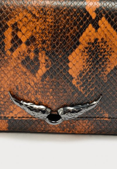 Brown and black snake-print wallet, featuring a textured surface and a shiny black wing-shaped clasp in the center.