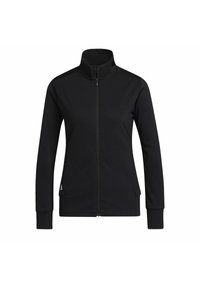 Schwarze zip-up Jacke aus einem strukturierten Stoff mit hohem Kragen, langen Ärmeln und seitlichen Taschen. Mit dezentem Logo-Detail am Saum.