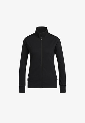 Chaqueta negra con cremallera hecha de una tela texturizada, con un collar alto, mangas largas y bolsillos laterales. Presenta un sutil detalle del logo cerca del dobladillo.