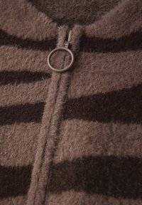 Brunrandig ull zip-up kofta med rund halsringning och en silverfärgad cirkulär dragkedjeöppnare, med en mjuk och fluffig textur.