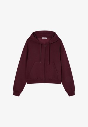 Felpa con zip color bordeaux, dotata di una comoda tasca frontale, cordini e polsini a coste. Tessuto morbido in misto cotone con una vestibilità rilassata.