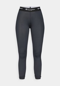 Czarne legginsy sportowe wykonane z gładkiego, elastycznego materiału. Posiadają szeroki pas ze logo "Champion" oraz dopasowany krój.