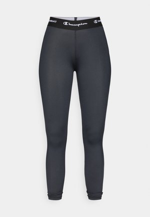 Svarte atletiske tights laget av et glatt, elastisk stoff. Har bred midjebånd med "Champion"-logo og tettsittende silhuett.