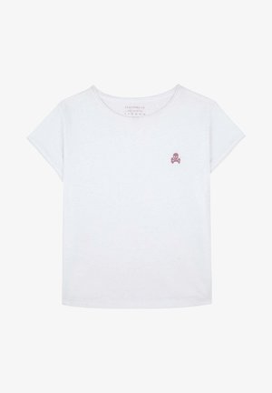 Valkoinen lyhythihainen lasten T-paita, jossa on pieni vaaleanpunainen pääkallo ja ristiluut -logo vasemmassa rinnassa ja pyöreä kaula-aukko.