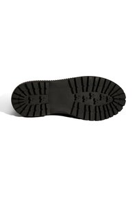 Zwarte rubberen laars met een diepe profielzool, voorzien van een gestructureerd oppervlak en driehoekige grippatronen voor verbeterde grip. Vlak en breed ontwerp.