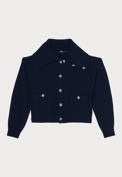 Navy knitted cardigan with a large ribbed collar, silver buttons, two front pockets, and cuffed sleeves. Textured fabric with structured shape.