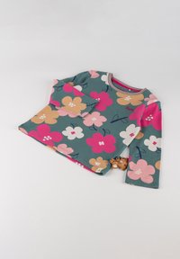 Langärmliges Oberteil in Teal mit großen rosa, weißen und beigen Blumenmustern. Verfügt über einen gerippten Kragen und pinkfarbene Saumdetails. Enthält einen kleinen Tieranhänger.