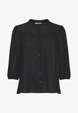 Blouse noire avec un col haut, fermeture à boutons sur le devant et manches ballon. Le tissu est transparent avec un léger motif à pois en relief, coupe décontractée.