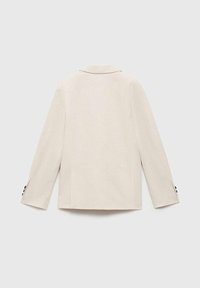 Beige skräddarsydd blazer med slagkrage, långa ärmar, dubbla ventiler bak och svarta knappdetaljer på ärmsluten. Slät, texturerad tygfinish.