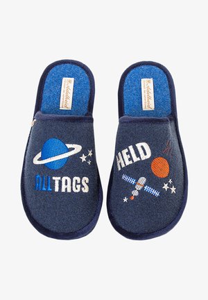 Navy blue felt slippers with space-themed embroidery. Features a planet, stars, satellite, and text "ALL TAGS" and "HELD" in contrasting colors.