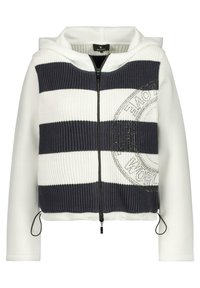 Hettejacka med en mörkblå och vit randig stickad framdel, släta vita ärmar, dragkedja och en logotyp med rhinestones.