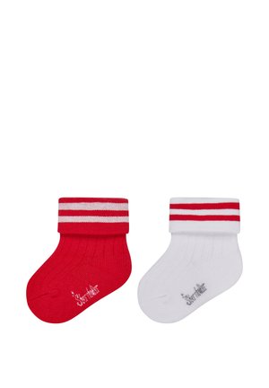 Pair of baby socks, one red and one white, each with two horizontal stripes on the cuff and small printed text near the toe.