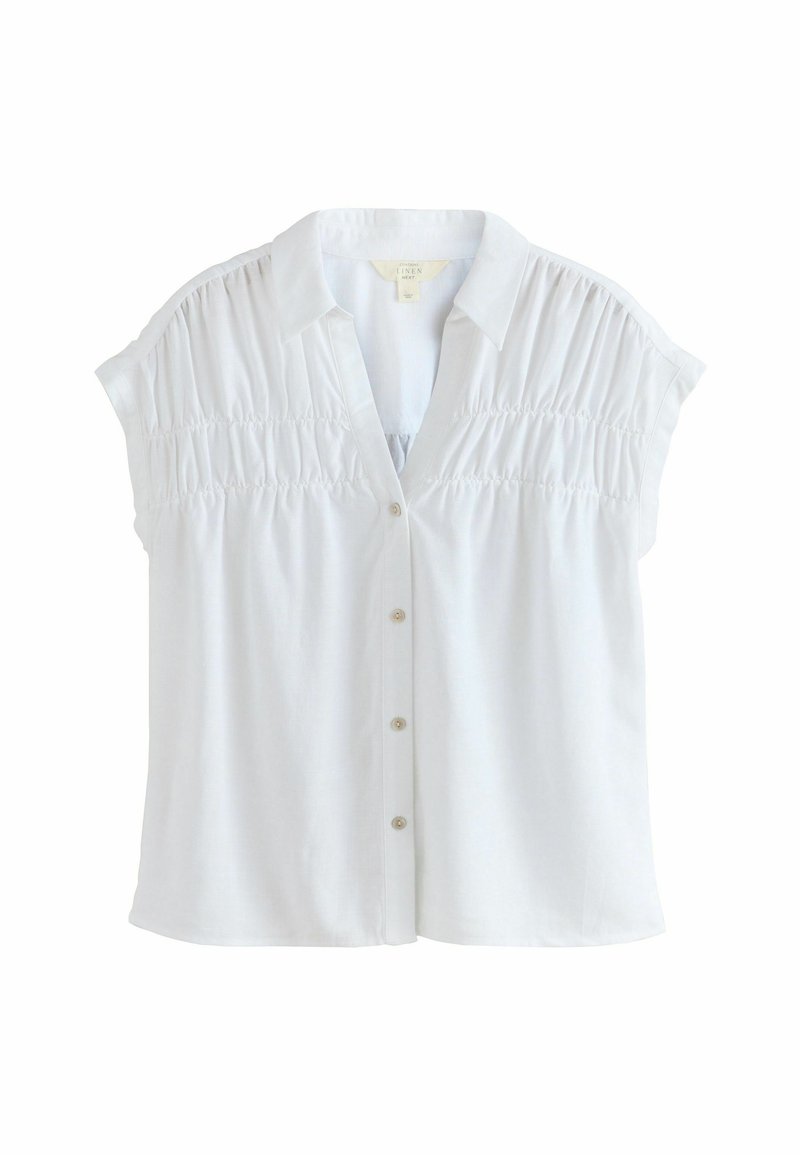 Biała koszula z krótkimi rękawami, z miękkiego lnu, z guzikami z przodu i marszczeniami na ramionach i bokach. Klasyczny kołnierzyk.