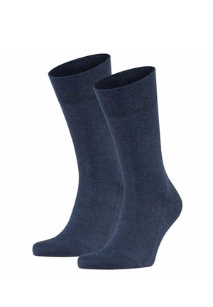 Pair of plain dark blue mid-calf socks standing upright with ribbed cuffs, smooth knit texture, and no visible logos or patterns.