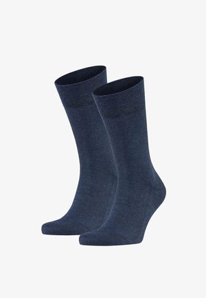 Pair of plain dark blue mid-calf socks standing upright with ribbed cuffs, smooth knit texture, and no visible logos or patterns.