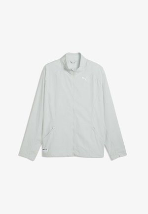 Jasnoszara kurtka na długi rękaw z zamkiem błyskawicznym, z kołnierzem typu stójka i logo Puma na lewym biuście, przedstawiona rozłożona na białym tle.