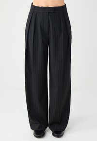 Czarne spodnie w prążki z zakładkami, wykonane z gładkiego materiału. Szerokie nogawki, z eleganckim paskiem w talii i subtelnymi niebieskimi paskami.