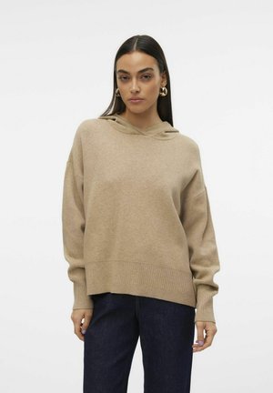 Felpa in maglia beige con una vestibilità comoda, orlo e polsini a coste. Il tessuto sembra morbido, con una texture liscia e un design semplice.