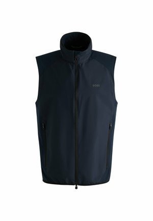 Granatowa bezrękawnik wykonany z lekkiego materiału, z wysokim kołnierzem, zamek błyskawiczny z przodu i kieszeniami na zamek po bokach. Logo umieszczone na klatce piersiowej.