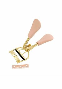 Un recourbe-cils doré avec des poignées en caoutchouc rose ; il dispose d'une bande en silicone noire et d'un accessoire peigne rose. Design compact adapté pour les voyages.