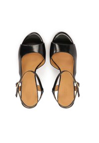 Black patent leather sandals with open toe design, beige inner lining, adjustable ankle strap, and a rounded heel.