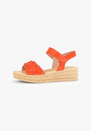 Orange leather wedge sandals feature knotted design on the upper, adjustable ankle strap, and a layered jute-like platform sole.