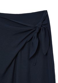 Jupe bleu marine avec un nœud sur le côté et une fermeture éclair dissimulée à la taille.