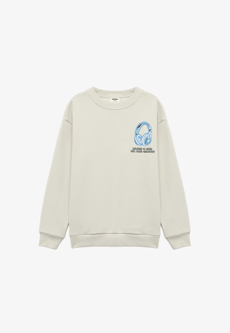 Lichtbeige sweatshirt met een grafische weergave van blauwe koptelefoons en de tekst "Blootstelling aan muziek zal creativiteit veroorzaken" op de borst, geribbelde manchetten en zoom.