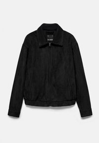 Veste noire à fermeture éclair avec col côtelé, ourlet élastique, manches longues et poches latérales, présentée sur un fond clair uni.