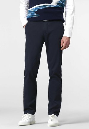 Navy blue trousers with a straight-leg design, featuring a smooth texture and pockets, paired with white sneakers.