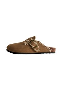 Brown suede slip-on shoe with a decorative buckle and stitching detail. Cork footbed and rubber sole for grip and comfort.