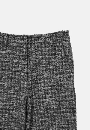 Textured black and white woven fabric pants with a straight cut, featuring a fitted waistband and subtle stitching details.