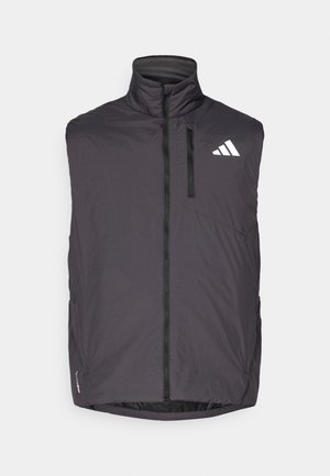 Szary bezrękawnik z wysokim kołnierzem, zamkiem błyskawicznym z przodu oraz kieszenią na lewej piersi. Posiada białe logo i lekki materiał.