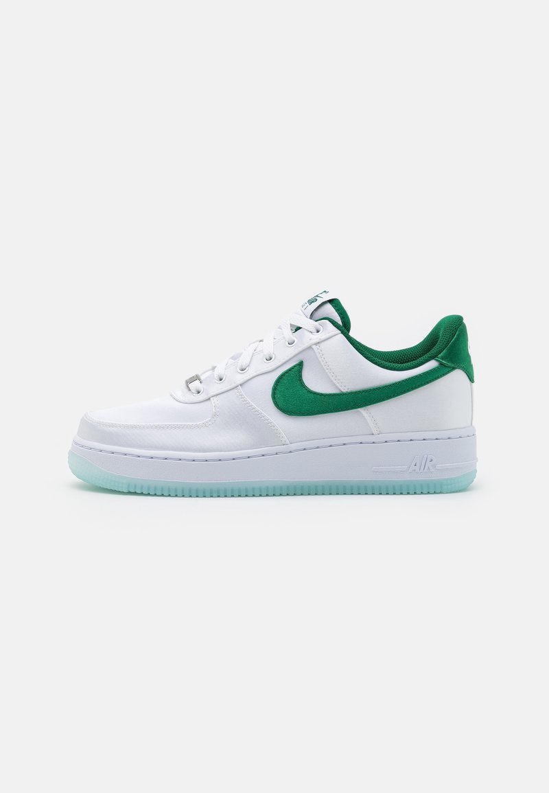 White Nike sneakers with green accents, featuring a smooth synthetic upper, padded collar, and translucent mint-colored outsole.