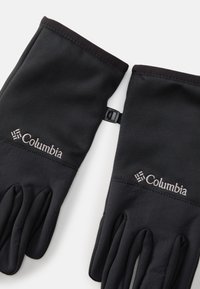 Melnas cimdi, kas izgatavoti no elastīga auduma, ar ciešu piegulšanu, teksturētu plaukstu un Columbia logo. Iekļauta regulējama siksna drošai valkāšanai.