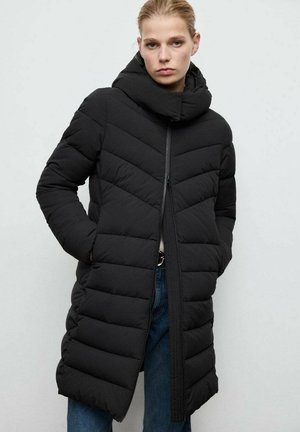 Black puffer coat with a high collar, featuring a chevron quilted pattern and a front zipper. The fabric appears smooth and insulated.