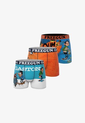 Trois boxers colorés avec une ceinture "FREEGUN" et le personnage de dessin animé Gaston Lagaffe imprimé sur des fonds bleu, orange et turquoise.