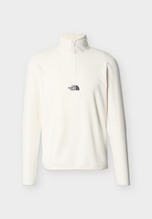 White long-sleeve fleece pullover with a quarter-zip collar and black "The North Face" logo on the chest.