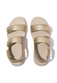 Metaalkleurige gouden sandalen met twee brede banden, een gevoerd voetbed en een gladde zool die ontworpen is voor comfort.