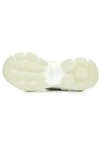 Shoe sole featuring a smooth, white rubber material with rounded traction pods and a central circular pattern for grip and stability.