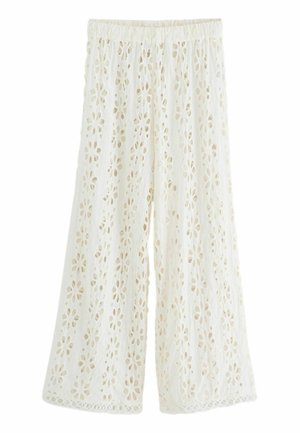 Witte, wijde broek van geborduurd stof met een bloemenmotief in snede. Elastische tailleband met geschulpte randdetails.