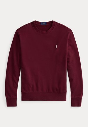 Burgundy sweatshirt with a crew neck, long sleeves, ribbed cuffs and hem, featuring a small embroidered logo on the left chest. Made of soft fabric.