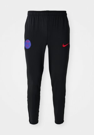 Pantalons de sport noirs en tissu lisse. Présentent un logo Nike rouge et un emblème bleu de Paris sur la gauche. Taille élastique avec jambes fuselées.
