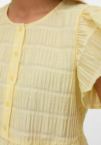 Lichtgele gestreepte blouse met een ronde halslijn, knopen aan de voorkant en korte, gerimpelde mouwen van een zachte, gestructureerde stof.